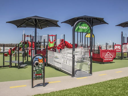 front end of a park with two black covers overhead with a green sign hanging down that says start